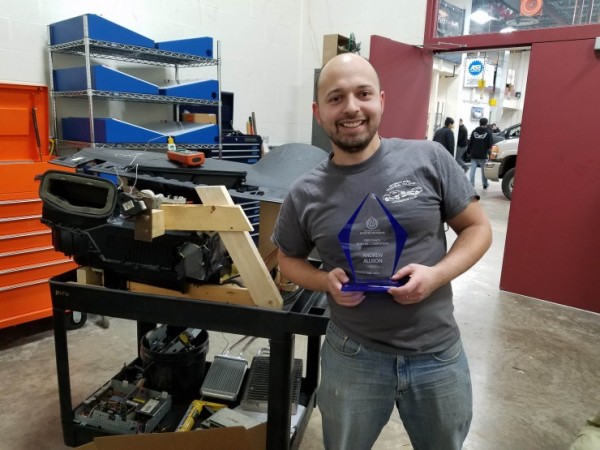 Andrew Allison holds award.