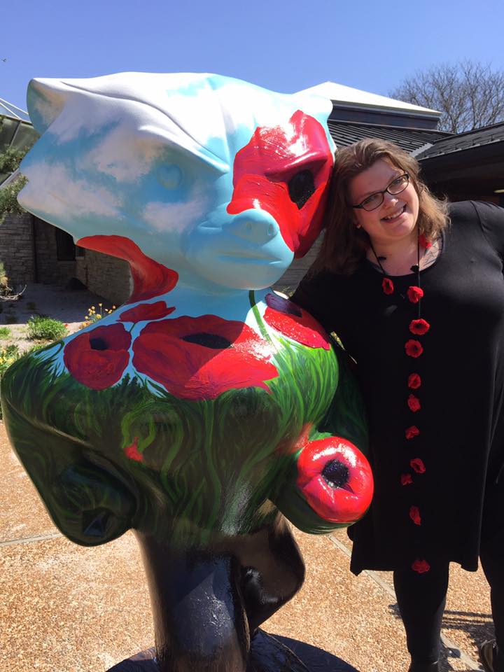 Instructor Emmalee Pearson stands with Grow Bucky.