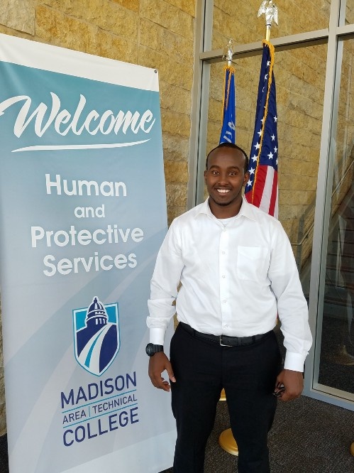 Zakariya Mohamud stands by flags
