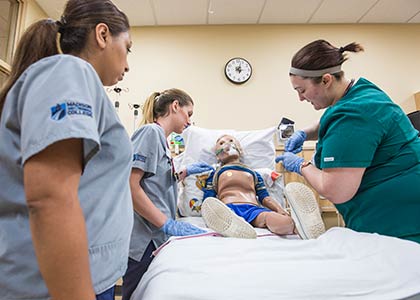 nurses gather around simulation patient