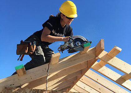 Madison College construction student working on a roof truss